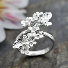 Our eye catching Forget Me Not Cluster Ring makes an unforgettable gift. A perfectly pretty cluster of flowers set on a stunning silver ring. A charming and sweet gift, one that exudes love and friendship without the obvious heart symbolism. Whether its a gift for a spring bride, friend on her travels or a little treat just for you it is sure to bring a smile to any woman's face. This Sterling Silver Forget Me Not Cluster Jewellery is delicately designed to symbolise the close bonds of love, friendship and family. A pretty present for that someone special evoking memories of you every time they are adorned with this adorable accessory. With its adjustable design this ring can be gently squeezed to make it shrink or stretch accommodating a range of finger sizes. Make sure this one size fits Cheap Silver Flower Ring For Wedding, Delicate Spring Flower Ring Gift, Delicate Flower Ring For Spring Gift, Dainty Spring Jewelry For Anniversary, Dainty Jewelry For Spring Anniversary, Dainty Jewelry For Anniversary In Spring, Spring Wedding Rings With Flower Shape, Spring Wedding Rings In Flower Shape, Flower Shaped Wedding Rings For Spring