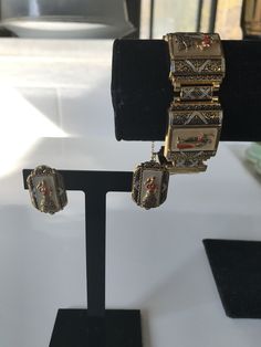 "Gorgeous gold gilt and mother of pearl in-laid Spanish toledo damascene five link bracelet featuring a lady dressed in a flamenco dress and a bull fighter in alternate panels. The bracelet has a push in slide closure and also comes with a safety chain. According to Wikipeda \"Damascening is the art of inlaying different metals into one another--typically, gold or silver into a darkly oxidized steel background--to produce intricate patterns similar to niello\". Approximate measurements: Bracelet Gold Collectible Bracelet, Collectible Enamel Bracelet Jewelry, Collectible Yellow Gold Bracelet, Collectible Hallmarked Metal Jewelry, Collectible Costume Jewelry Bracelet, Antique Decorative Jewelry For Formal Occasions, Collectible Hallmarked Bracelet Jewelry, Collectible Hallmarked Bracelet, Victorian Pierced Jewelry For Ceremonial Occasions