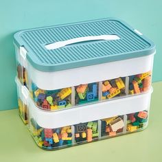 two plastic storage containers with legos in them