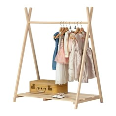 a wooden rack with clothes hanging on it and an open suitcase in the foreground