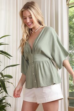 Unleash your daring side with our SS deep V neck button down top! The plunging neckline and stylish buttons make for a playful and versatile piece. Perfect for a night out or adding a touch of edginess to your everyday wardrobe. *Deep V neckline button down blouse with draped sleeves*Pattern type : solid* Color : sage*Neck line : V neck*Sleeve type : kimono sleeves*Sleeve length : short sleeves*Stretch : no stretch*Sheer : lined at upper front, no see through*Functional buttons for opening *Care Kimono Blouse, Sustainable Wardrobe, Draped Sleeves, Athleisure Tops, Distressed Denim Skirt, Drape Sleeves, Sage Color, Kimono Sleeves, Halter Tops