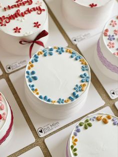 many decorated cakes are on display for sale