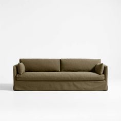 a beige couch sitting on top of a white floor