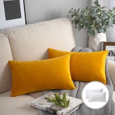 two yellow pillows sitting on top of a white couch next to a potted plant