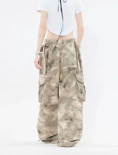 Embrace the street aesthetic with our Faded Baggy Camo Cargo Pants, perfect for making a statement while on the move.
Designed with a natural waist, these cargo pants offer a blend of comfort and durability. The camouflage pattern adds an edgy touch, while the drawstring and convenient pockets provide functionality and ease. The relaxed wide-leg silhouette ensures a nonchalant yet purposeful style, tailored for the contemporary wardrobe.
Pair them with a cropped hoodie and sneakers for running e Summer Utility Cargo Jeans For Streetwear, Summer Hip Hop Cargo Jeans With Cargo Pockets, Combat Style Baggy Wide Leg Bottoms, Spring Cotton Combat Cargo Pants, Spring Combat Cotton Cargo Pants, Y2k Style Baggy Parachute Pants For Summer, High Waist Hip Hop Cargo Pants For Summer, Hip Hop High Waist Cargo Pants For Summer, Y2k Summer Cargo Pants