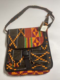 Kente Sensation Christopher Amwelima Messenger Bag National Geographic  Condition: New with Tags Color> Multi Color Hand measured: Height 16" - Width 14.5"  Brand: Novica National Geographic Multicolor Satchel With Detachable Strap For School, Multicolor Pouch Satchel For School, Rectangular Multicolor Satchel For School, Multicolor Flap Bag With Removable Pouch For Travel, Multicolor Crossbody Flap Bag For Travel, Multicolor Shoulder Flap Bag With Adjustable Strap, Multicolor Flap Shoulder Bag With Adjustable Strap, Multicolor Rectangular Flap Bag For Travel, Multicolor Rectangular Flap Bag For Daily Use