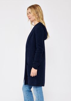 An ultra warm and cozy mid-length hooded cardigan in navy. Fuzzy texture Relaxed fit Long sleeve Mid-length Hooded Open front Patch pockets Women's fall cardigan Dry clean only Embrace all the cozy vibes in this ultra-soft long cardigan - your new Fall favorite! This versatile layering piece features an open front, a comfy hoodie, long sleeves, and convenient patch pockets. You'll find yourself reaching for this easy fit style all season long. Model is 5'7.5, wearing a size S.Style: I-51072K-SLQ Comfy Soft Knit Outerwear For Cold Weather, Cozy Blue Soft Knit Outerwear, Cozy Hooded Cardigan With Pockets, Cozy Hooded Sweater Coat For Cold Weather, Hooded Soft Knit Cardigan For Cold Weather, Soft Knit Hooded Outerwear For Cold Weather, Cozy Fit Hooded Soft Knit Outerwear, Cozy Fit Soft Knit Hooded Outerwear, Blue Winter Cardigan For Loungewear