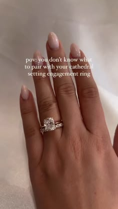 a woman's hand with a ring on it and the words pay you don't know what to pair with your cathedral setting engagement ring