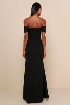 a woman in a black dress looking back