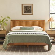 a bed sitting in a bedroom next to two lamps on either side of the bed