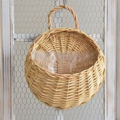 a wicker basket hanging from the side of a door