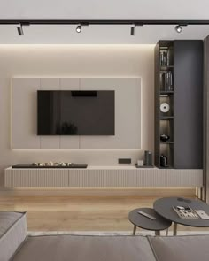 modern living room with white walls and wood flooring, large television on the wall