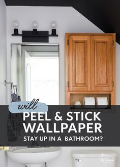 a white toilet sitting next to a bathroom sink under a wooden cabinet in a bathroom