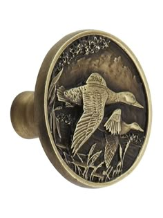 an antique style door knob with a bird on it