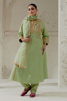 Green padded kalidar cut kurta with floral embroidery on the yoke and sleeves. Paired with a chanderi dogri salwar and embroidered organza dupatta. - Aza Fashions Pista Green Cotton Silk Anarkali Set With Cutdana, Tissue Silk Churidar For Reception, Chanderi Churidar For Eid Reception, Art Silk Straight Kurta Churidar For Reception, Art Silk Churidar For Reception With Straight Kurta, Pista Green Anarkali Kurta With Gota Work, Festive Chanderi Churidar For Reception, Pista Green Traditional Wear With Gota Work For Reception, Fitted Tissue Silk Palazzo Set With Gota Work