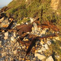 the remains of an old railroad track on rocks and grass