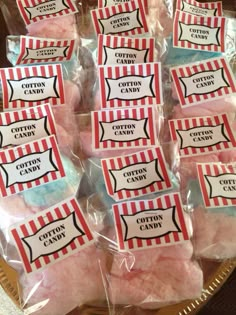 some cotton candy is wrapped in plastic and sitting on a plate with labels that say cotton candy