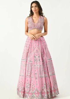 This modern lehenga in pastel hues features geometric and floral prints highlighted with embroidery detailing. The blouse comes with a deep V neckline adorned with beads and sequins all over. A cape with gathers is added to give you that chic look in an ethnic wear. Bollywood Sequin V-neck Dress, Embellished Georgette V-neck Set, Designer V-neck Lehenga For Festivals, Embellished V-neck Georgette Sets, V-neck Georgette Sets With Mirror Work, V-neck Sets With Mirror Work In Georgette, V-neck Dress With Mirror Work For Reception, Elegant Lehenga With Zari Work And V-neck, Anarkali V-neck Set For Reception