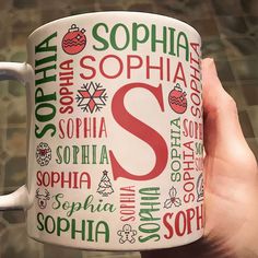 This personalized Christmas mug is the perfect way to bring holiday cheer to your daily coffee or tea routine. Featuring a colorful design with festive elements like snowflakes, Christmas trees, ornaments, and gingerbread men, this mug is customized with your name prominently displayed in various fonts and sizes. The bold initial in the center makes it stand out, while the alternating red and green color scheme captures the joyful spirit of the season. Whether it's for yourself or as a thoughtfu Christmas Trees Ornaments, Personalized Christmas Mugs, Self Gift, Green Color Scheme, Tea Routine, Leather Flask, Grandson Gift, Green Color Schemes, Cozy Mornings