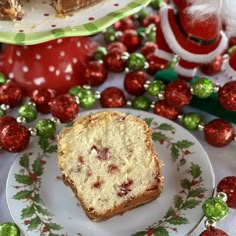 a piece of cake sitting on top of a white plate next to a santa clause hat