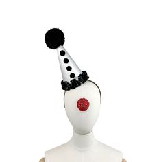 Clown Hat On Headband. Black and White, Circus Hair Accessory, Halloween Costume, Handmade Pom Pom, Birthday Party, Photo Prop This mini clown hat is made from a white satin over a buckram frame that has been also covered in another layer of fabric underneath- so it's super sturdy and has a perfectly smooth surface. The pom pom on top is black and hand made! It stands 8" inches high. You won't see a hat like this anywhere else! It comes on a headband that goes through elastic on the botton so you can slide it into any position on your head. I use only the most comfortable headbands that fit kids or adults comfortably. Calling all party girls! Clown couture is the new black! Great for kids, too! Shipping Policy: All items are sent through the US Postal Service first class with tracking. Ple Novelty Costume Hats And Headpieces For Parties, Novelty Party Costume Hats And Headpieces, Themed Party Hat For Carnival, Novelty High Crown Costume Hats For Parties, Fun White Costume Hats And Headpieces For Party, White Fun Party Costume Hats And Headpieces, Novelty Party Hat Supplies, Whimsical Costume Hats For Carnival Party, Whimsical Costume Hats And Headpieces For Carnival Party