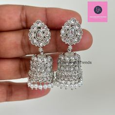 Silver Polki Jhumka/Stone Jhumka/Indian earrings/Indian Jewelry/Pakistani/Punjabi/Indian/Statement earring/Bridal earring/Indian wedding Antique Jhumki With Rhodium Plating Height = 45 mm || Width = 22 mm Classic Jhumki Antique Earring Closure: Pushback This is 100% Handmade jewelry. So Color, shades, and texture displayed may vary slightly from the actual product due to digital image limitations. We request you to consider these minor variations. Please expect the possibility of some slight imp Hand Set Bollywood Jhumkas, Hand Set Traditional Jhumkas, Silver Chandbalis For Wedding And Festive Occasions, Festive Silver Chandelier Earrings With Tilla, Festive Silver Chandelier Earrings With Stone Work, Silver Kundan Bridal Earrings For Eid, Silver Stone Work Earrings For Wedding, Silver Meenakari Chandelier Earrings For Celebration, Silver Bollywood Tikka With Latkans