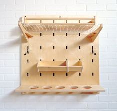 a wooden shelf that has some sort of object on it, hanging from the wall