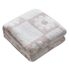 two towels folded on top of each other in front of a white background with pink flowers