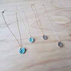 "These adjustable 16\"-18\" necklaces have 1/2\"x 1/4\" charms, which are a dainty-yet-noticeable addition to any outfit. Each charm is handmade and stamped with an upward print,  fired, then coated with glaze on one side and refired. The backside of the charm is left unglazed, open-surface for diffusing essential oils (or perfumes). The ceramic bead becomes warm as you wear it, and in turn, the aroma of the oil will be released. One drop of my favorite essential oil (Stress Away) on the back an Adjustable Hand Stamped Charm Necklace For Everyday, Everyday Adjustable Hand Stamped Charm Necklaces, Adjustable Friendship Pendant Necklace, Adjustable Tiny Charm Necklaces For Everyday, Blue Necklace With Adjustable Length For Gifts, Adjustable Pendant Necklace For Friendship, Adjustable Hand Stamped Charm Necklace With Round Pendant, Nickel-free Round Pendant Necklaces For Friendship, Nickel Free Round Pendant Necklaces For Friendship