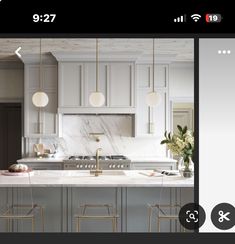 a kitchen with white cabinets and marble counter tops, in the middle of an instagramtion