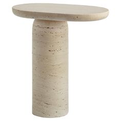 a white table with a circular top on it's pedestal, against a white background