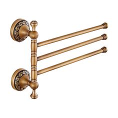 an old fashioned brass towel rack with decorative knobs on the front and back ends