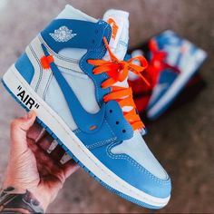 The Sneakers Come In A White, Dark Powder Blue And Cone Colorway, With A White And Blue Deconstructed Leather Upper And Off-White Detailing Throughout. Shoes Include Blue And Orange Strings Nike Air Jordan Off White, Designer Blue High-top Custom Sneakers, Off White 1s, Off White Jordans, Air Jordan Off White, Air Jordan 1 Off White, Off White Jordan 1, Jordan 1 Off White, Jordan Off White