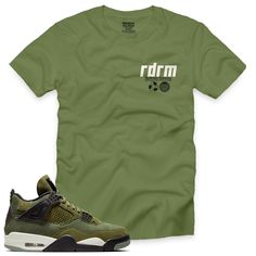 "This Olive 4 Redrum V6 Tee is essential for any urban streetwear enthusiast. Show off your style in this premium 100% cotton tee, featuring a classic fit and green/black/natural short-sleeve design. Inspired by the SE craft \"OLIVE\" 4s 2023. Get your true-to-size Redrum Nation tee today.   (Sneakers not included)." Graphic Tee For Streetwear In Khaki, Khaki Graphic Tee For Streetwear, Khaki Cotton T-shirt For Streetwear, Summer Khaki T-shirt For Streetwear, Green Cotton T-shirt For Streetwear, Sporty Khaki Cotton T-shirt, Sporty Khaki Short Sleeve T-shirt, Khaki Relaxed Fit T-shirt For Streetwear, Green Urban Cotton T-shirt