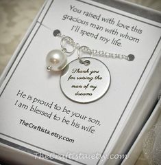 This elegant piece of jewelry will make a beautiful and sentimental gift that will best express your gratitude and love for your groom's mom. This necklace has been featured in a Treasury List, see last photo.This piece includes:8mm authentic shell pearl pendant  and a 20mm disc pendant engraved with the words "Thank you for raising the man of my dreams." The charms dangle from a silver-plated 18-inch chain.Gift Card reads:You raised with love this gracious man with whom I'll spend my life.He is Meaningful Wedding Jewelry For Mother's Day, Meaningful Jewelry For Wedding And Mother's Day, Personalized Silver Necklaces For Special Day, Stainless Steel Jewelry Hallmarked For Anniversary, Stainless Steel Jewelry With Hallmark For Anniversary, Personalized Necklaces For Valentine's Day, Round Wedding Jewelry With Gift Box, Adjustable Wedding Jewelry With Gift Box, Personalized Stainless Steel Jewelry For Wedding Gift