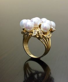 DeKara Designs Collection Beautiful Art Deco/Vintage/Modern Style Halo Diamond Pearl Cocktail Ring. Metal- 14K Yellow Gold, .583. Stones- Nine 6.5 MM Round Tahitian/South Sea Pearls, 20 Round Diamonds F-G Color SI2 Clarity 0.72 Carats. A handmade truly magnificent 14K Yellow Gold Pearl Diamond Ring. There is a beautiful cluster pearl ring with diamonds that are dazzling surrounding the pearls. This ring is perfect! The diamonds are stunning and make the pearls pop! You have a total of nine pearl Pearl Ring Gold, Art Deco Pearl, Pearl Diamond Ring, Pearl Cocktail Ring, Vintage Modern Style, Gold Pearl Ring, Pearl And Diamond Ring, Gold Art Deco, Deco Vintage