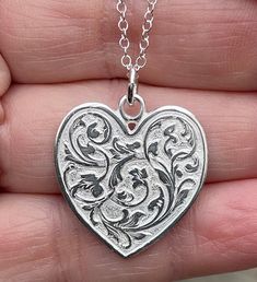 "Sterling silver heart is extremely detailed, made from a hand engraved model. It measures 29mm by 24mm ( without rings on top). Comes with 18\" sterling silver chain. 6.7g. Available in 14kt gold also. Money back guarantee within 14days. Buyer pays return shipping and must be returned in original condition with box and no alterations." Engraved White Gold Sterling Silver Locket Necklace, Antique Silver Engraved Jewelry For Valentine's Day, Engraved Antique Silver Jewelry For Valentine's Day, Silver Engraved Sterling Silver Locket Necklace, Silver Heart-shaped Etched Jewelry, Antique Silver Engraved Heart Jewelry, Silver Engraved Double Heart Necklace, Silver Double Heart Engraved Necklace, Engraved Sterling Silver Locket Necklace