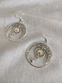 These gorgeous drop earrings feature filigree moons, suns, and star charms enclosed in a celestial circle. Perfect piece for a little everyday magic! Choose between silver or bronze Celestial Star Jewelry For Festival, Celestial Star-shaped Festival Jewelry, Celestial Festival Star Jewelry, Celestial Silver Pierced Jewelry, Silver Moon Bohemian Jewelry, Silver Moon Shaped Jewelry For Festivals, Celestial Style Silver Metal Jewelry, Celestial Style Silver Jewelry, Celestial Star-shaped Metal Jewelry