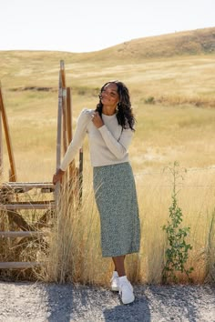 Adorned with dainty florals, this skirt brings a touch of feminine charm to any occasion. Whether you're dressing up for a special night out or keeping it casual, this skirt's timeless cut and pattern makes for the perfect style companion. slight high-low elastic waist unlined black // paired with the miles city sweater sienna // paired with the lancaster pocket sweater in ivory darkseagreen // paired with the fortnight sweater vest steelblue // paired with the patti button tank A Line Skirt Outfits Casual, Cute Skirts Long, Formal Meeting Outfit, Midi Floral Skirt Outfit, Casual Skirt Outfits Modest, Long Skirt With Sweater, Sweater Vest With Skirt, Maxi Skirt And Sweater, Winter Church Outfits For Women