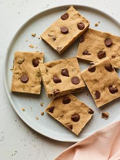 several pieces of chocolate chip cookie dough on a plate