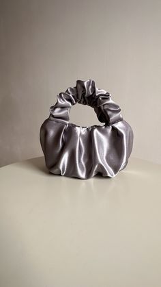 Silver evening bag made from smooth satin. Stylish designer woman bag is soft, but keeps its shape, closes with a magnetic button. Small satin bag is able to decorate not only official event, but also becomes a companion for every day. Perfect wedding bag. Scrunchies handbag consists of 3 layers: the outer material and the lining are satin, with a special seal between them so that the handbag keeps its shape. Small evening handbag can also be sewn from soft pleasant velvet. Material: Soft, pleas Elegant Solid Color Evening Bag, Elegant Gray Pouch Bag, Elegant Party Bag With Satin Finish, Elegant Satin Finish Evening Bag For Party, Chic Satin Clutch Evening Bag, Elegant Satin Evening Bag With Satin Finish, Elegant Gray Bag For Gift, Elegant Satin Pouch Evening Bag, Satin Clutch Bag For Party