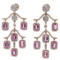 This earrings features 7.38 carats of emerald cut pink sapphire, each pink sapphire are surrounded by white round diamonds with a t.c.w of 3.45 carats. Earrings are set in 18 karat rose gold. Length 2 inch Width 0.95 inch Pink Sapphire 7.38 carat Diamond 3.45 carat Luxury Chandelier Earrings With Rose Cut Diamonds, Luxury Pink Jewelry For Festive Season, Pink Diamond Jewelry, Pearl Chandelier Earrings, Diamond Chandelier Earrings, Diamond Chandelier, Earrings Outfit, Pearl Chandelier, Historical Jewellery