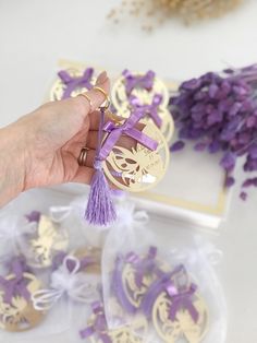 a person holding some purple and gold decorations