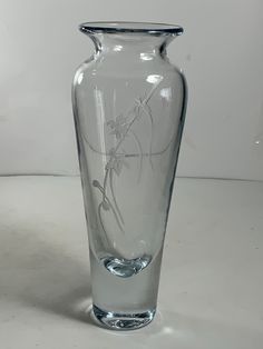 a clear glass vase sitting on top of a table