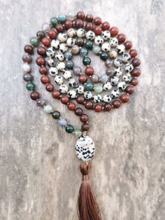 A mala is a Buddhist prayer rosary consisting of 108 beads + 109 Guru Bead. Each bead is threaded on a silk cord and separated by a knot tied during meditation and chanting (mantra recitation).  This handcrafted mala by me is made of Jasper, Dalmatian Jasper, and Indian Agate stones.  The mala is completed with a Guru Bead in the form of Dalmatian Jasper. The bead diameter is 6mm. Bohemian Hand-strung Healing Rosary, Bohemian Hand-strung Rosary For Healing, Bohemian Agate Mala With Gemstone Beads, Adjustable Agate Hand-strung Mala, Bohemian Rosary With 108 Beads For Healing, Adjustable Hand-strung Agate Mala, Agate Gemstone Beads Mala For Meditation, Adjustable Agate Mala With 8mm Beads, Adjustable Agate Mala With Round Beads