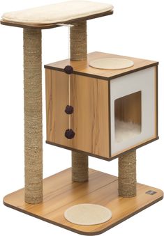 the cat tree is made from wood and has two scratching pads on top of it