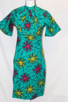 This beautiful Gown is made from pure African print. The gown is lined and fitted with zipper. good for work and any classy events  * 100% Cotton, no stretch * Handmade  * Length: 40"  SIZING https://buymych.com/sizing Kindly review size chart before making a purchase. Size chart is available. We recommend going up a size if you are in between sizes.  FABRIC CARE Note that our African Prints do not stretch.  DO NOT BLEACH. Machine wash SEPARATELY.  Warn iron on the wrong Side. Fitted Green Dress With Back Zipper, Fitted Green Sheath Maxi Dress, Green Fitted Sheath Maxi Dress, Green Printed Stretch Dresses, Fitted Green Printed Dresses, Green Stretch Printed Dresses, Green Lined Fitted Maxi Dress, Green Knee-length Dress With Back Zipper, Fitted Green Lined Dress