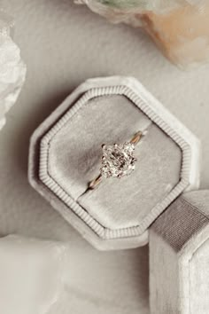 an engagement ring sitting on top of a box