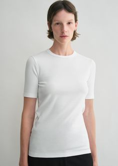 Short-sleeved TOTEME T-shirt made from ribbed cotton jersey with a hint of elastane for a comfortable slim fit and embroidered with a tonal monogram for discreet branding. Wear it throughout the year under sweaters and overshirts. White Cotton Essential T-shirt, Toteme White Shirt, Boxy White Cotton T-shirt, Fitted White Technical T-shirt, Technical Stretch White T-shirt, Travel Capsule, Grey T Shirt, Sweater Blazer, Swim Shop