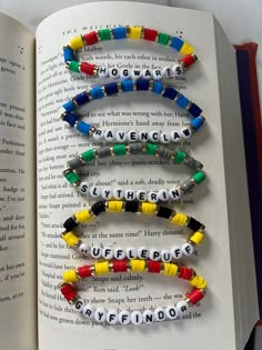 an open book with several beads on it and the words spelled out in different languages